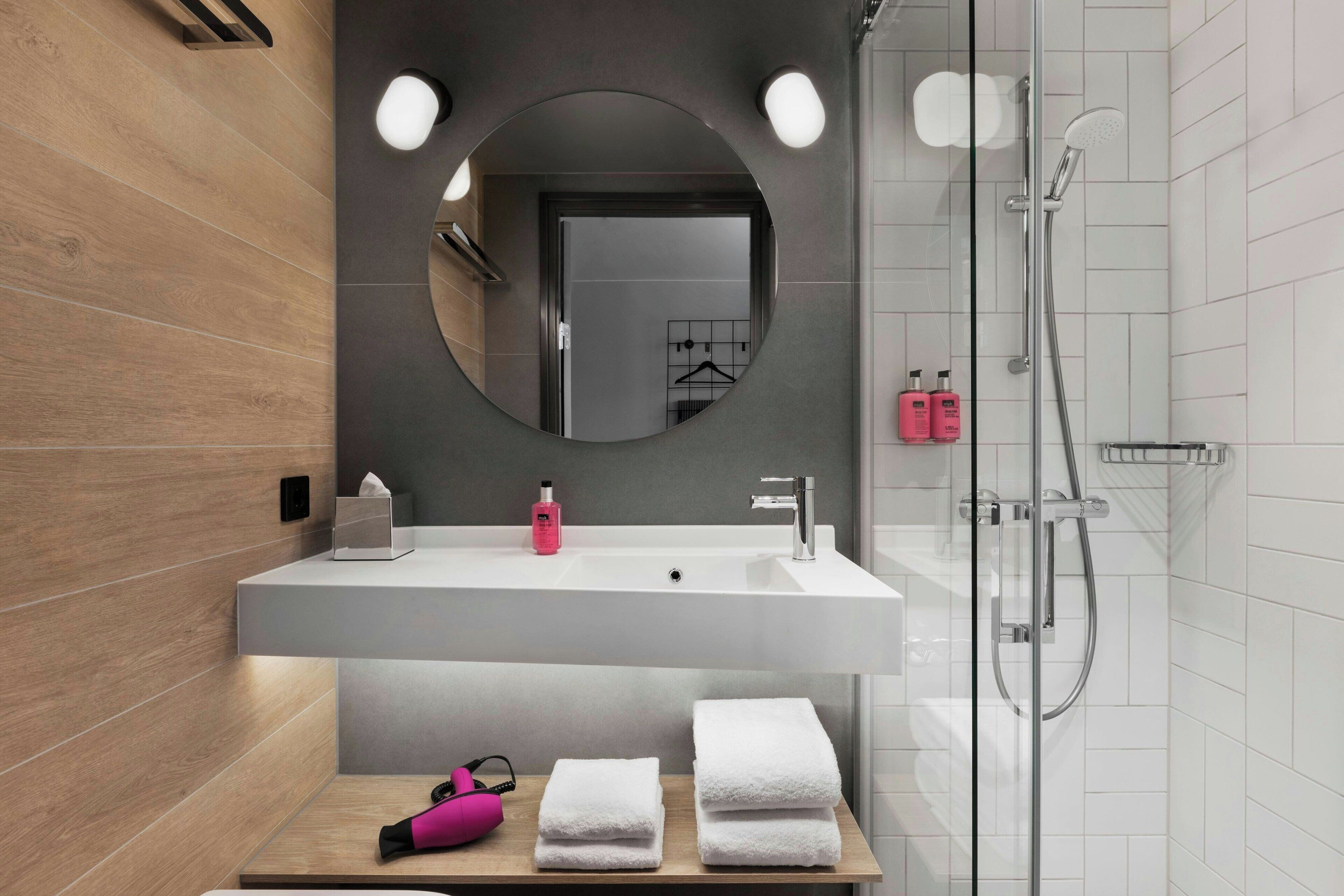 Shower, designer toiletries, hair dryer, towels