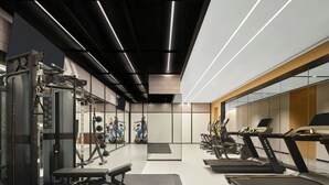 A modern gym with treadmills, weight machines, and a mirrored wall. - Four Points By Sheraton Shenzhen Airport (Shenzhen)