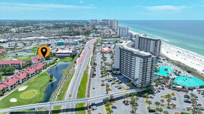 A coastal cityscape with a prominent hotel, a beach, and a golf course. - ~1B/2B Adorable Remodeled Edgewater Villa Near Beach & Attractions~ (Panama City Beach)