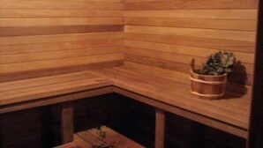 A sauna with wooden walls and a bench. - Delightful 4-bedroom Plus House in  East Chatham with Pool, Sauna and AC (East Chatham)