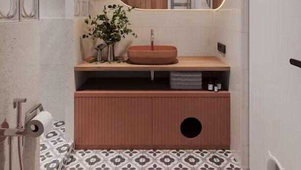 A bathroom with a wooden vanity, a round mirror, and patterned floor tiles. - Boavista Retreat Hotel (Porto)