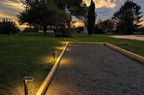 A well-maintained garden with a paved pathway leading to a seating area.