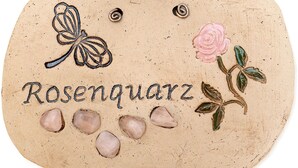 A decorative item with the word 'Rosengartz' and a butterfly, rose, and leaves. - Apartment Rosenquarz at Wolfgangsee Alpenblick (St. Wolfgnag)