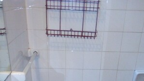 A bathroom with a white sink, a mirror, and a shower area. - Rentals las toninas costa beach (Las Toninas)