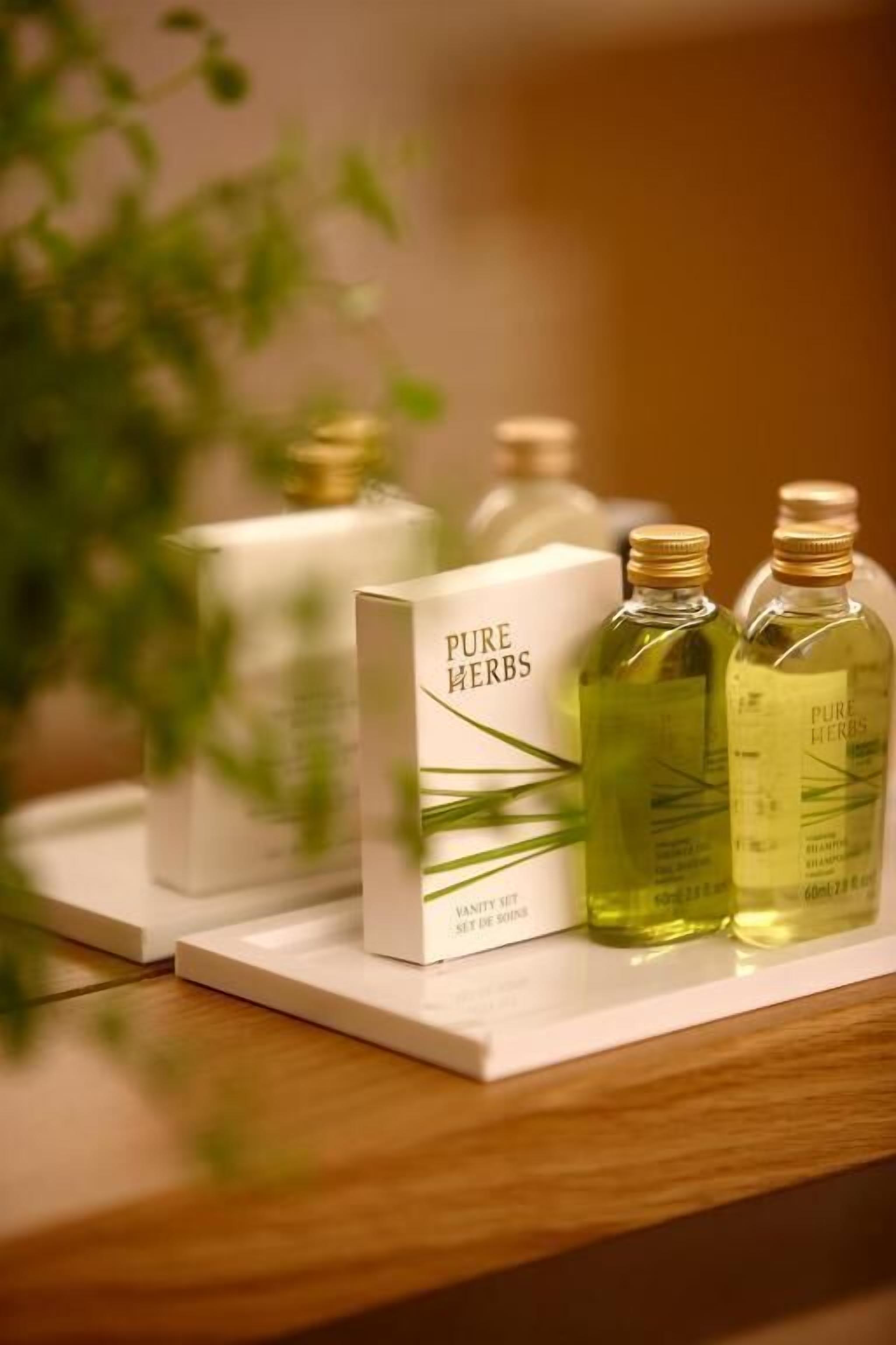 A set of products labeled 'PURE HERBS' on a white surface.