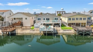 A waterfront property with multiple houses, a dock, and a water body.