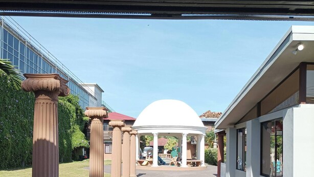 A pathway lined with columns leading to a white gazebo. - Studio 05 in Santa Ana Central, Convenient, and Comfortable (Santa Ana)