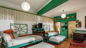 A room with two beds, a desk, a television, and a dresser. - Casa Belo Jardim - Studio with garden (Arco da Calheta)