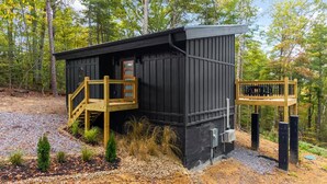 A small cabin with a wooden deck and a small porch. - Romantic Cabin - Hot Tub, Fire Pit Near Gatlinburg (Sevierville)