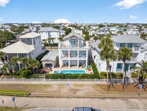 A multi-story house with a swimming pool, surrounded by palm trees and a white fence. - My Destin Vacation - Gulf Views & Private Pool (Destin)