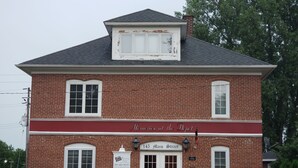 A brick building with a sign reading 'Memories at the Depot' and '145 Main Street.'