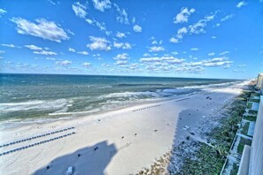 A beach with a clear sky, a sandy shore, and a view of the ocean. - Sunset Serenity 1302-Gulf Views-Sleeps 6 (Panama City)
