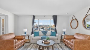 A living room with a sofa set, a coffee table, and a view of a parking lot. - Private Pool Paradise ~ 3BR Glendale Gem! (Glendale)