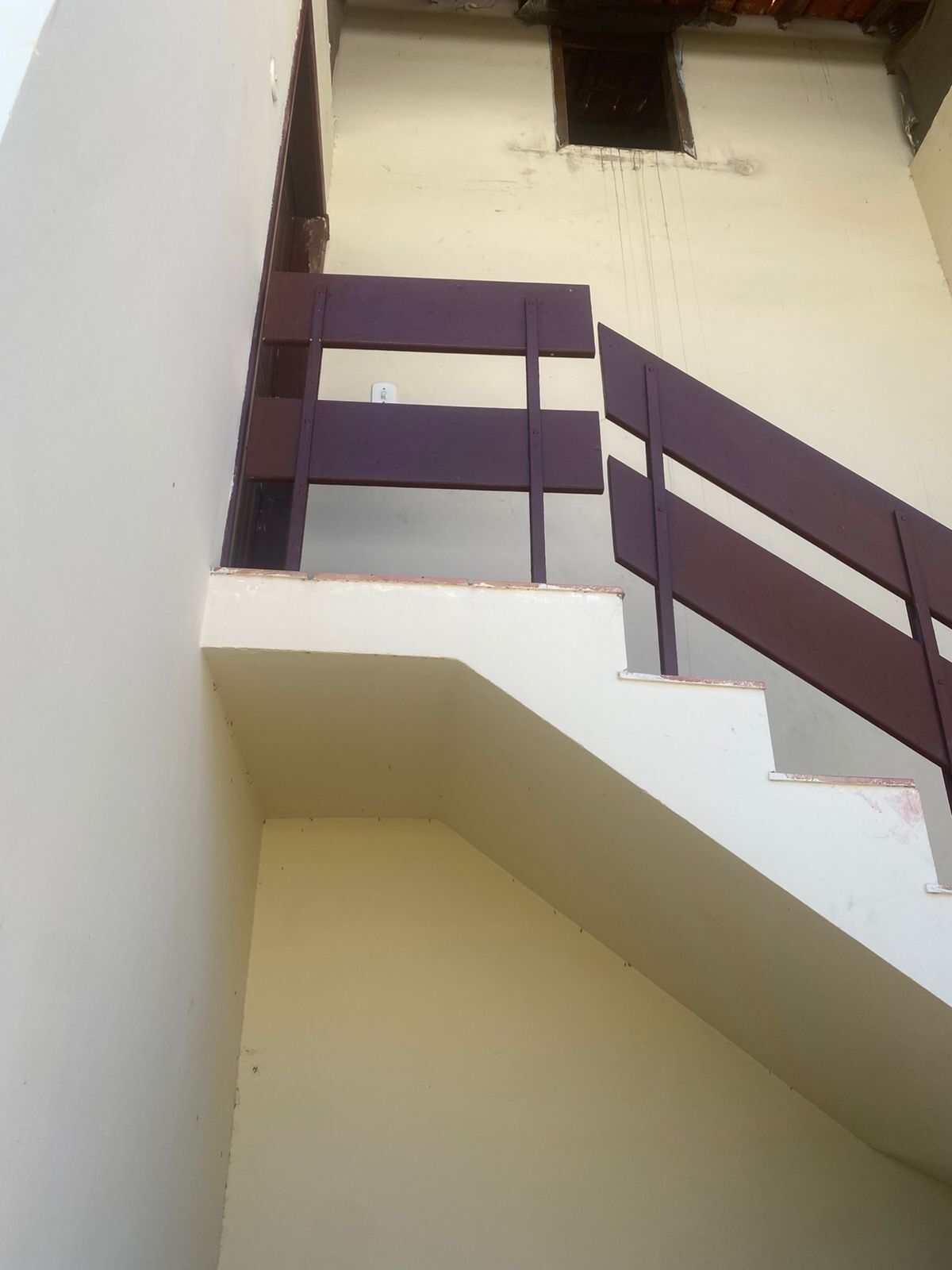 Un escalier avec une rampe et un palier.