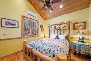 A bedroom with a bed, wooden ceiling, a window, a table, and a chair. - Charming Beech Mtn Retreat Near Slopes | Cozy Fireplace Escape (Banner Elk)