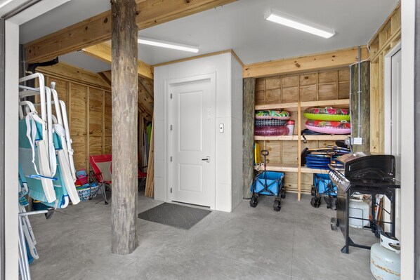 A room with a wooden ceiling, a white door, and shelves with various items. - Pelican Dive – Luxury Gulf-Front Home - Private Walk-Over - Chefs Kitchen & Bar (Navarre)