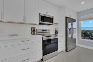 Fridge, microwave, oven, stovetop - Grand Bay 401 I Modern Coastal Retreat I Peaceful Island Escape I Walk To Shopping & Dining (Marco Island)