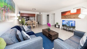 A modern living room with a sofa, coffee table, and artwork on the walls. - Stylish Brickell 1BR - Free Parking - Sleeps 6 (Miami)