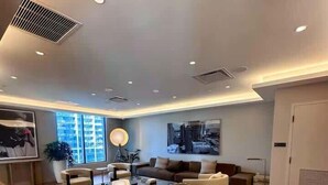 A spacious living area with a sofa set, a coffee table, and a floor lamp. - Lux Studio on 36th floor, Rooftop Pool, Prime Area (Miami)