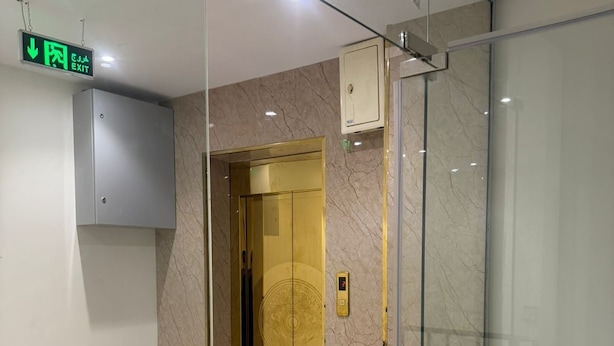 A modern elevator with a marble wall and a digital display. - asas rise (Riyadh)