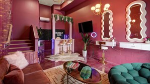 A modern interior with a staircase, a bar area, and a seating area with a sofa and a round table. - Aloha Nashville🤙🏻~ Private Sauna & Hot Tub | Rooftop Oasis | City Views | Close to Broadway! (Nashville)