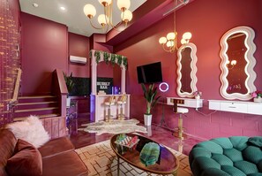 A modern interior with a staircase, a bar area, and a seating area with a sofa and a round table. - Aloha Nashville🤙🏻~ Private Sauna & Hot Tub | Rooftop Oasis | City Views | Close to Broadway! (Nashville)
