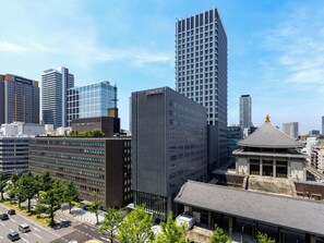 A modern cityscape with high-rise buildings, including a hotel with a distinctive facade. - SOLARIA NISHITETSU HOTEL OSAKA HONMACHI (Osaka)