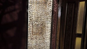 A doorway with a decorative hanging pattern, a tiled floor, and a wooden door frame. - Quaint 1-bedroom country house in tranquil farm (Masaya)