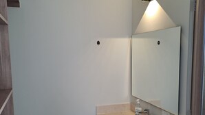 A bathroom with a wooden vanity, a sink, and a mirror. - 2-bedroom bed & breakfast in charming Cancun with AC (Cancun)