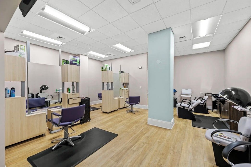 A dental clinic with multiple treatment rooms, dental chairs, and a reception area.