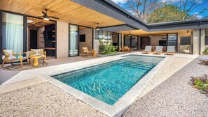 A modern house with a swimming pool, outdoor seating, and a covered patio area. - Architect-Designed Villa Pool & Chef's Kitchen (Playa Grande)