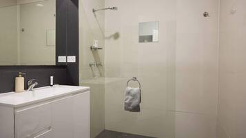 Shower, hair dryer, towels, shampoo