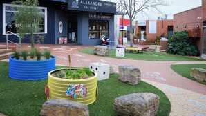 A restaurant named 'Alexandra Chicken + Square' with outdoor seating and a small garden area. - Templestowe Village - 2BR, Parking, Pet-Friendly (Templestowe)