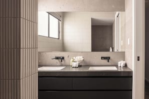 A modern bathroom with two sinks, a large mirror, and a window. - Maison by Khove (Broadbeach Waters)