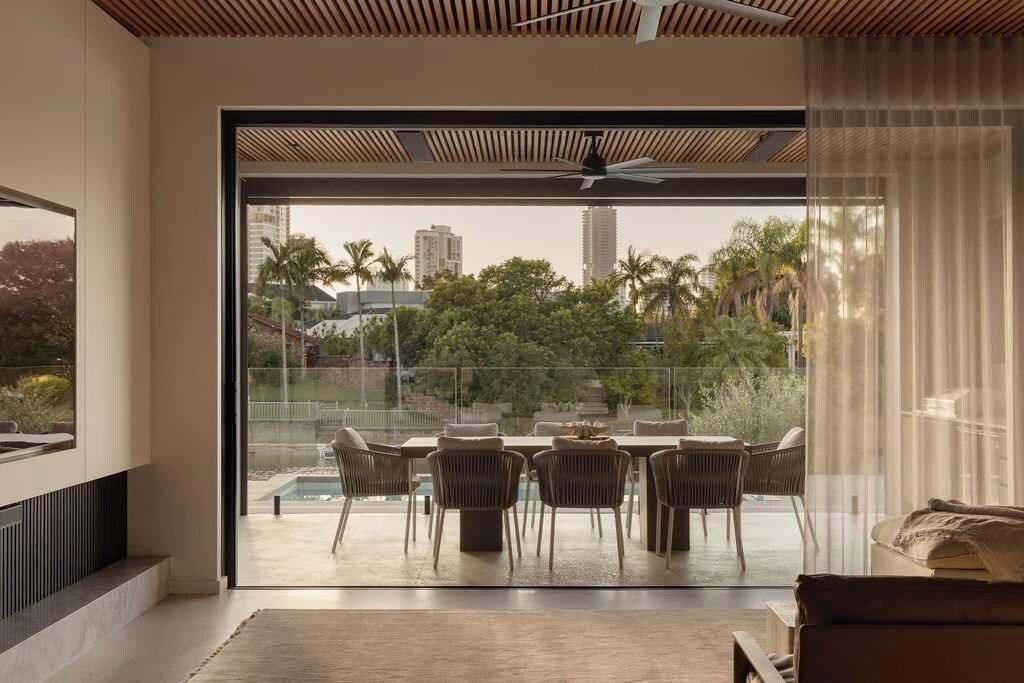 A modern living room with a large sliding glass door leading to an outdoor patio area.