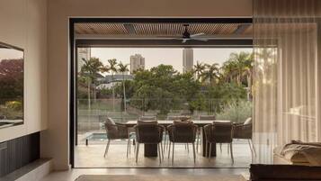 A modern living room with a large sliding glass door leading to an outdoor patio area.