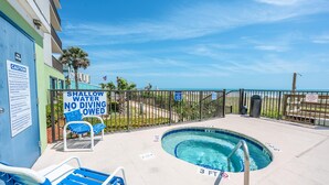 A pool area with a sign indicating shallow water and no diving.