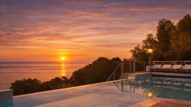 A swimming pool with a sunset view, wooden deck, and lounge chairs. - VILLA RITTER ORIZZONTE (Marina di Campo)