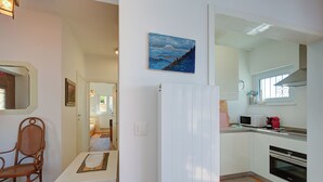 A compact kitchen with white cabinets, a microwave, and an oven. - La Ca Da Bre - Garden House With Views (Lugano)