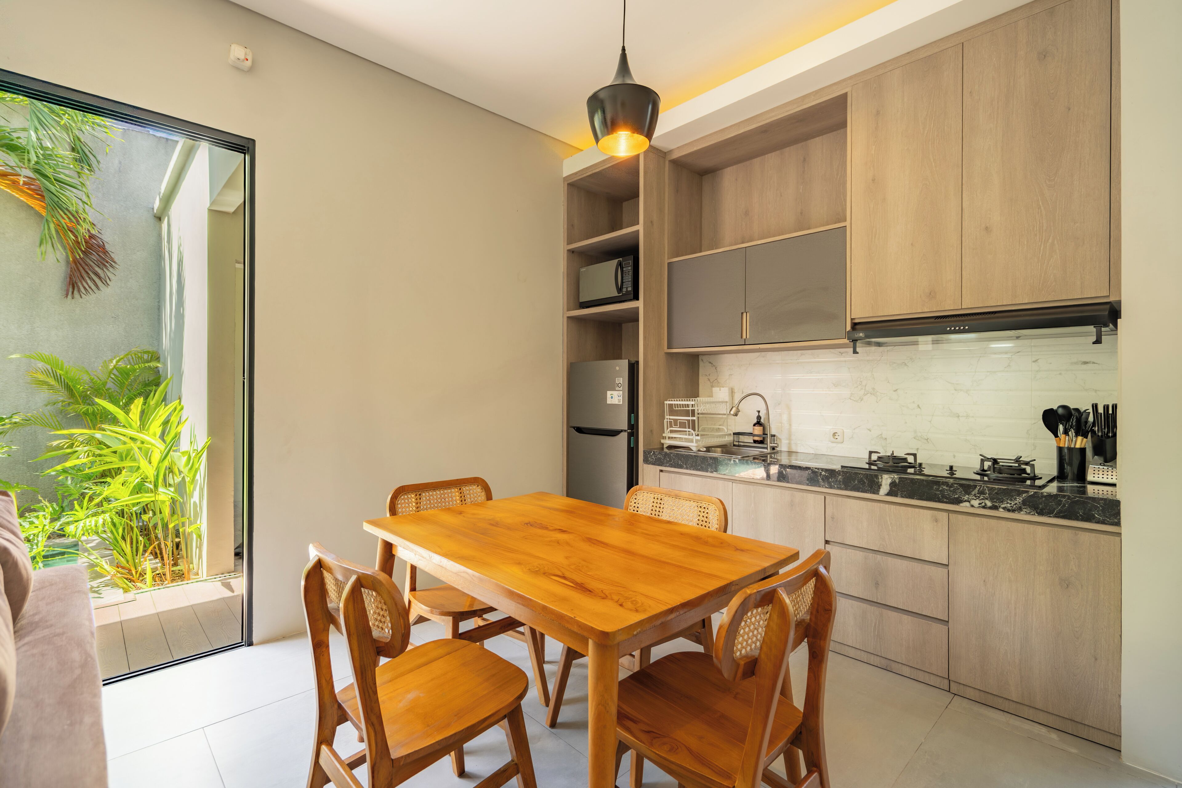 Una cocina moderna con armarios de madera, una mesa de comedor y sillas.