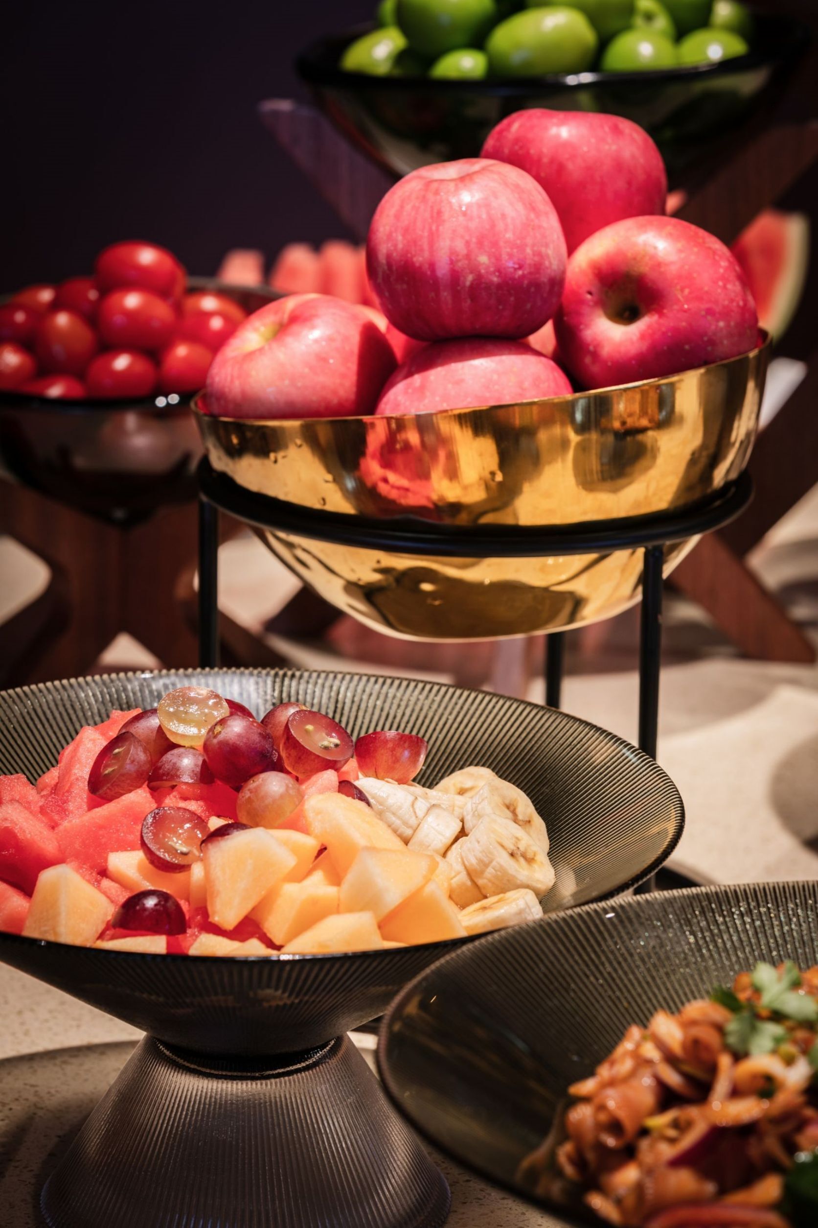 A buffet with various fruits and vegetables.