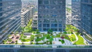 A high-rise building with multiple floors, large windows, and a central courtyard with greenery and seating areas. - MAISON NEW CENTURY (Ningbo)