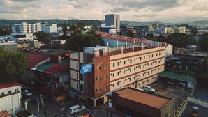 A multi-story hotel with a sign indicating 'HOTEL 801' and a view of the surrounding urban area. - Hotel 801 Inc. (Cagayan de Oro)