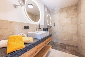 A modern bathroom with a rectangular sink, two mirrors, and a shower area. - (1) Vacation rental with a small terrace (Reit im Winkl)