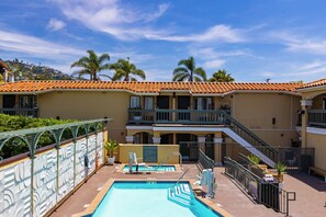 A pool area with a sign indicating 'Spa Rules' and a caution capacity limit. - Pool + Hot Tub + Rooftop + Ocean Views + Walk to Beach + Restaurant + Art Scene (Laguna Beach)