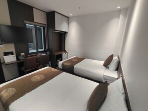 A hotel room with two beds, a desk, a chair, and a window. - CMC Hotel (Bac Giang)