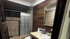 A bathroom with a bathtub, toilet, and sink.