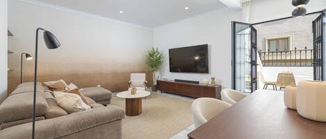 Una sala de estar moderna con un sofá, una mesa de centro y un televisor.