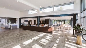 A spacious lobby with a reception desk, seating area, and large windows allowing natural light. - Hotel & Tagungszentrum Blaubeuren (Blaubeuren)