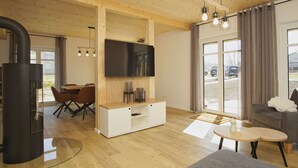 A modern living room with a fireplace, a flat-screen TV, wooden flooring, and a large window. - Strandhaus Anni - comfortable and modern vacation home - Strandhaus Anni (Mönchgut)